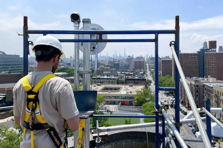 Worker on top of building overseeing New York City skyline