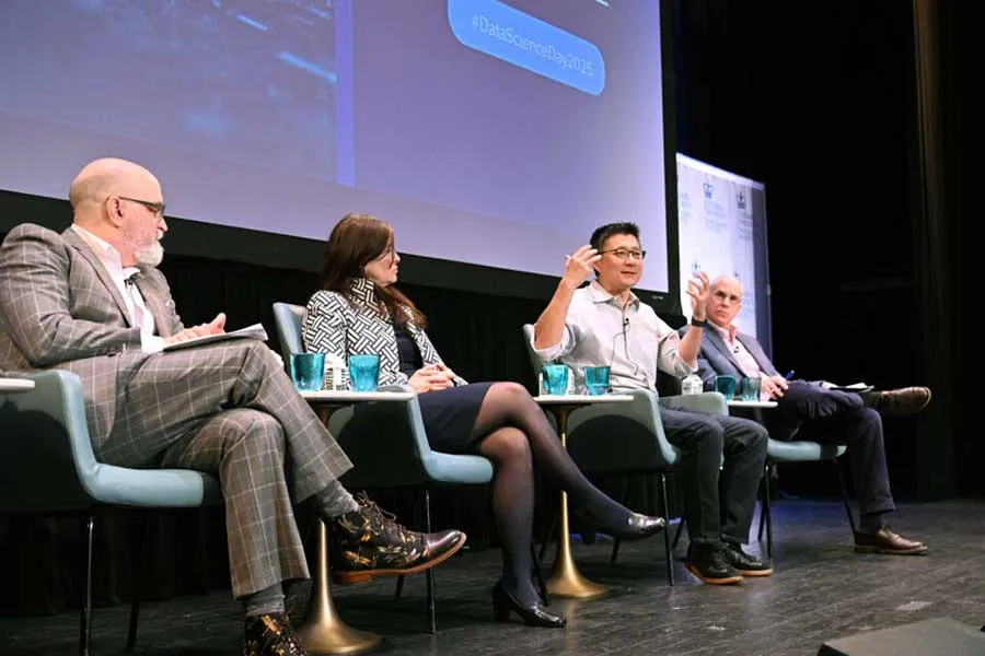 people seated on a stage involved in a discussion