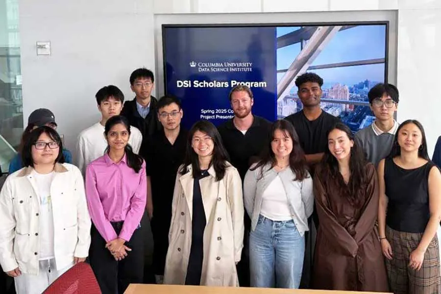 a group of 13 students smiling for the camera