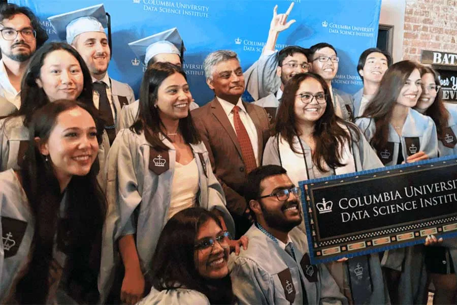 graduating students celebrating with Professor Garud Iyengar