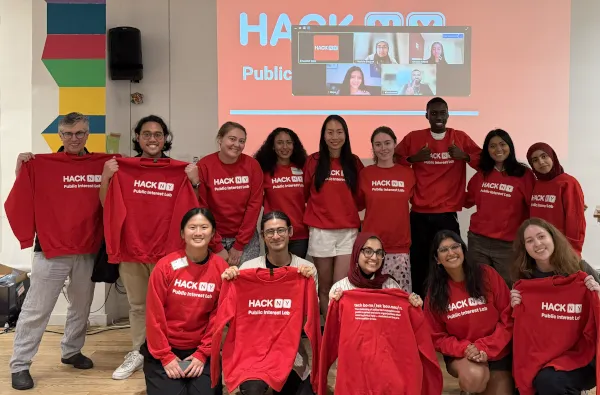 DSI Core Member Chris Wiggins with the inaugural cohort of hackNY Public Interest Lab Fellows, all in red t-shirts.