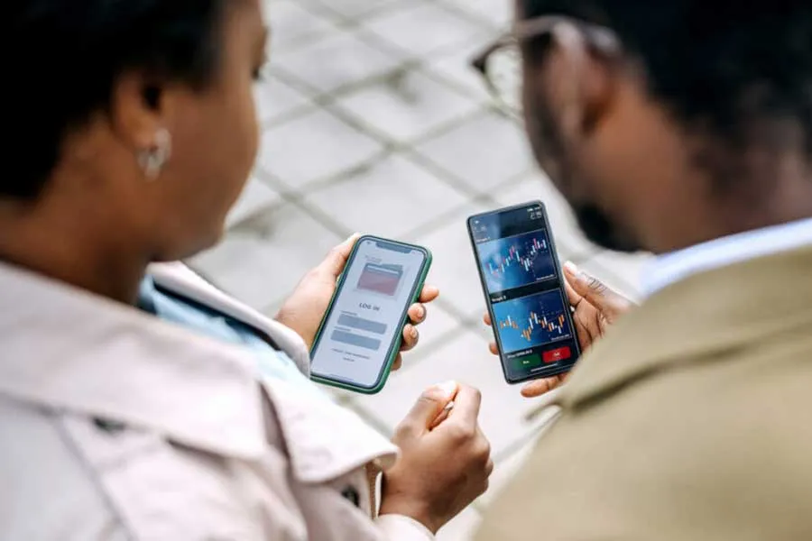 two people looking at their mobile phones