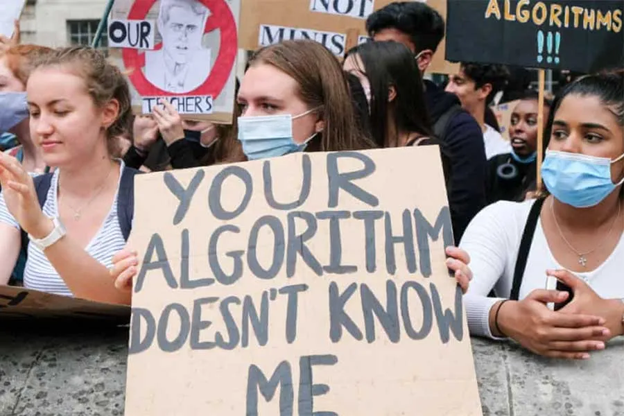 woman holding protest sign that reads, "Your algorithm doesn't know me"