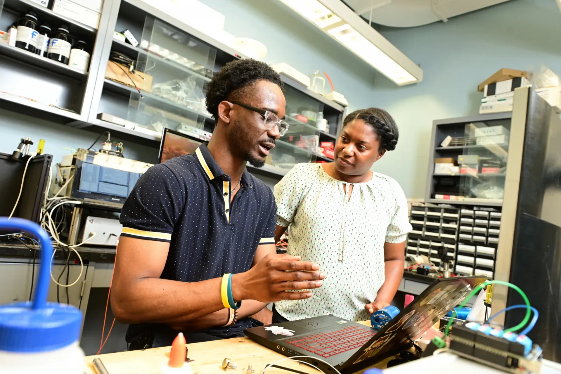 two researchers talking in a lab