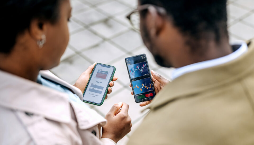 Young colleagues checking their bank investment app