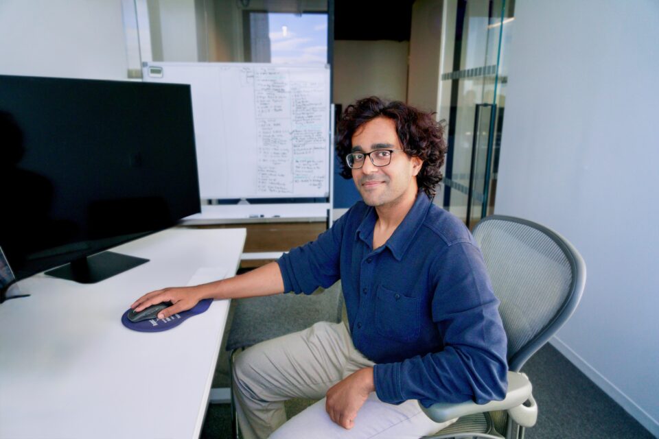 Vipul Harihar, alumnus at desk in office